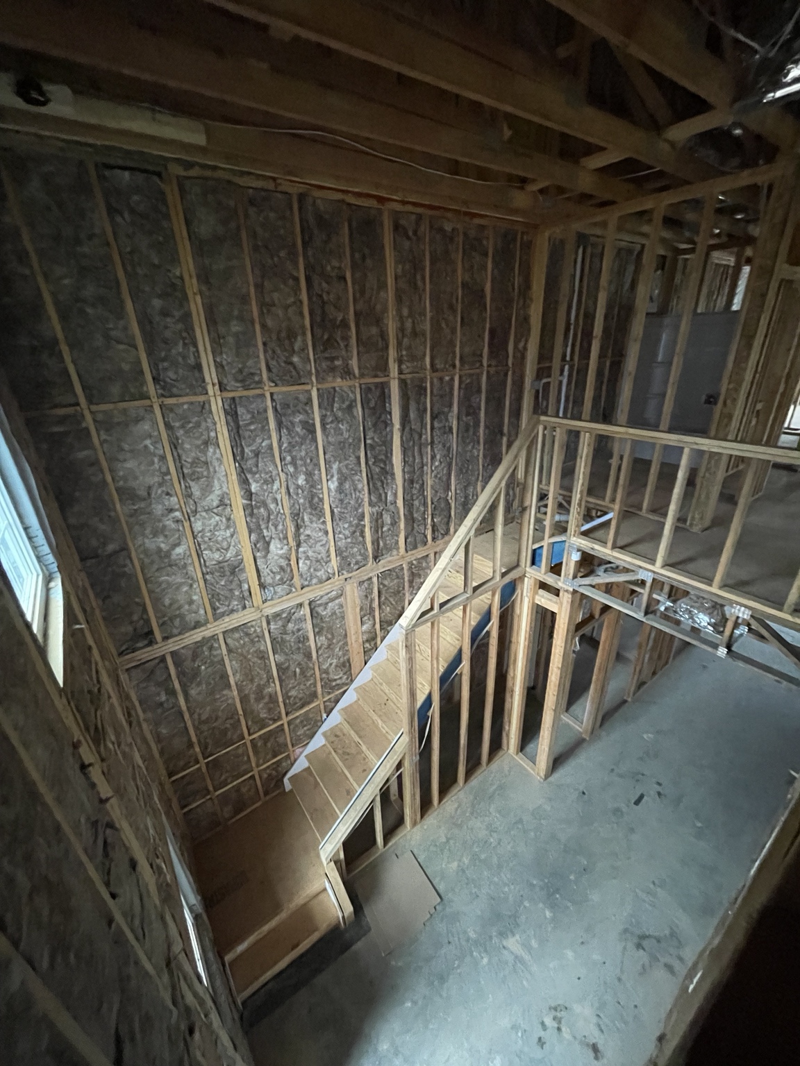 Fiberglass batt insulation installed throughout a multilevel townhome or apartment building