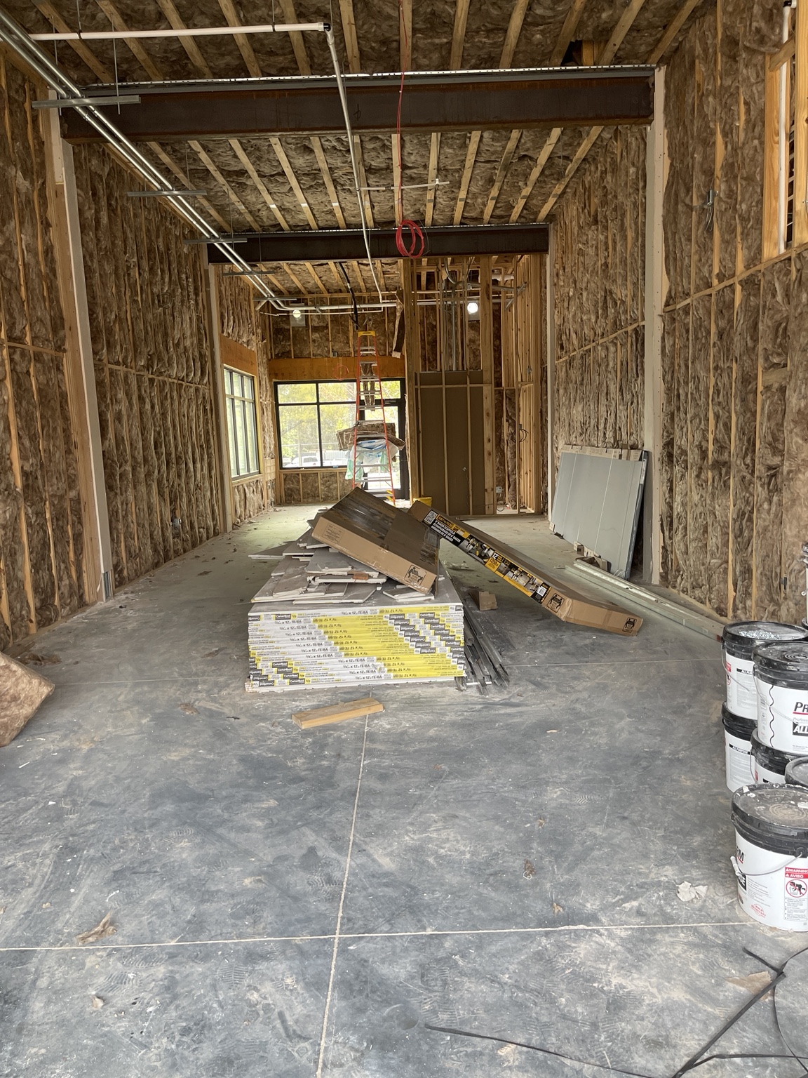 Completed fiberglass batt insulation in the walls and ceiling of a new building